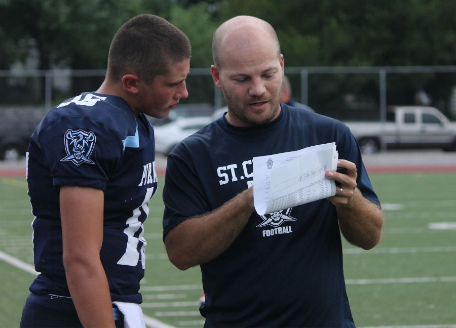 Sophomore Cody Thorne consults with Head Coach Joe Leibner about plays at the Jamboree on Aug. 12