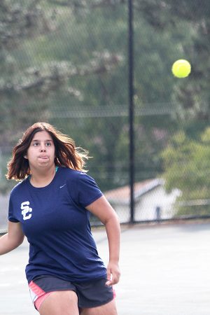 Senior Gabby Gibson eyes the tennis ball in her match against Troy Buchanan on Sept. 14.