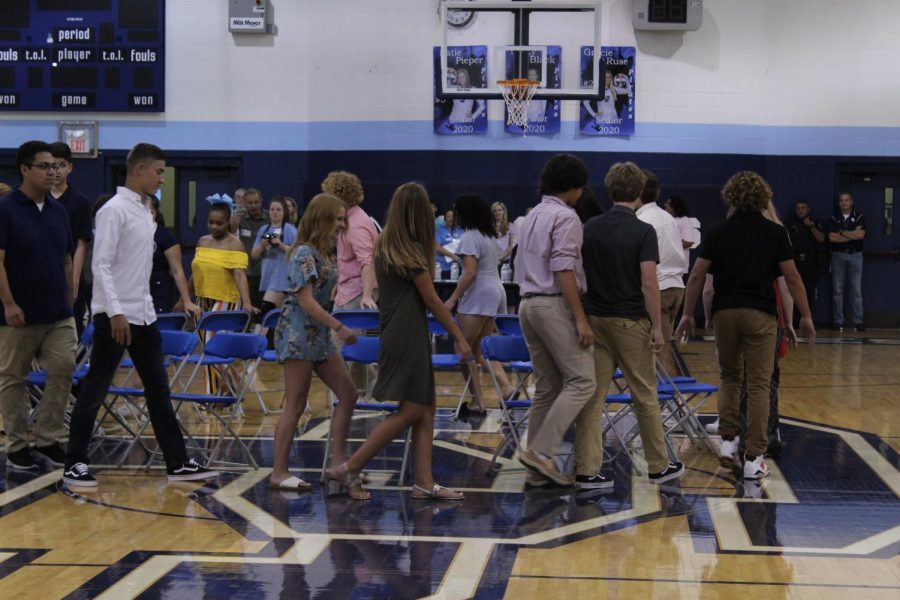 The homecoming court plays musical chairs.