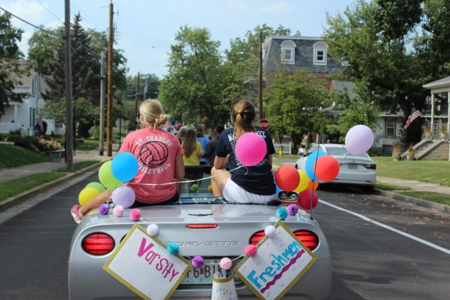 Volleyball players Gracie Ruse and Emily Black riding the volleyball float, representing the volleyball teams.