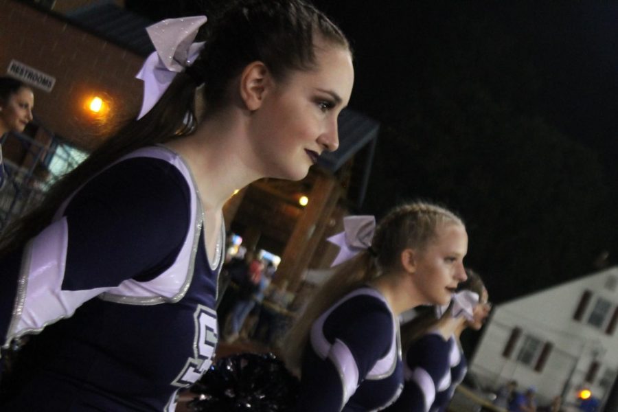 Marissa Sipe and Kat Lewis lined up with their team at a football game 