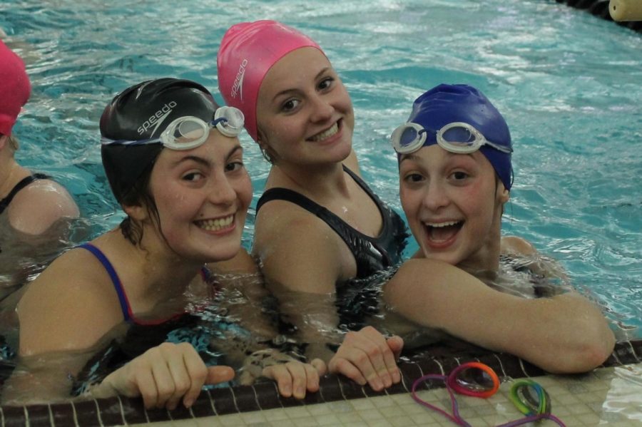 New+swimmers+Alaina+Thomas%2C+Molly+Pieper%2C+and+Katie+Black+laugh+together+at+practice+on+Dec.+3%2C+while+they+started+warming+up.