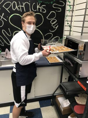 Nick Quay grabbing the fresh cookies from the oven!