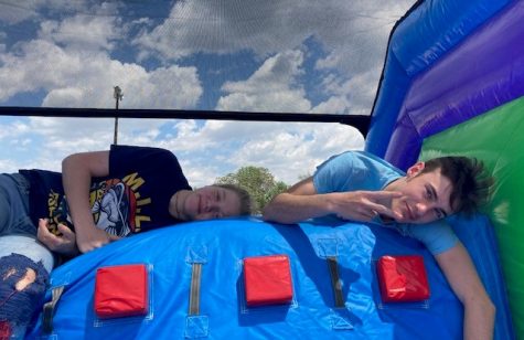 Libby McClanahan- Hluzek and Payton Irvin resting on top of the bouncy slide