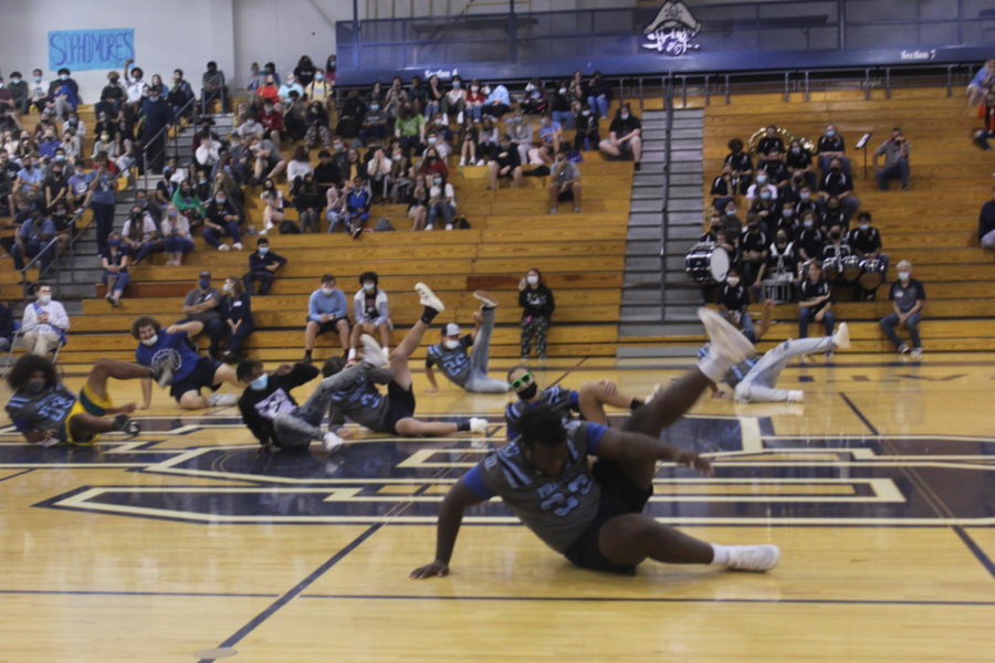 The football team shows their amazing moves at the assembly.