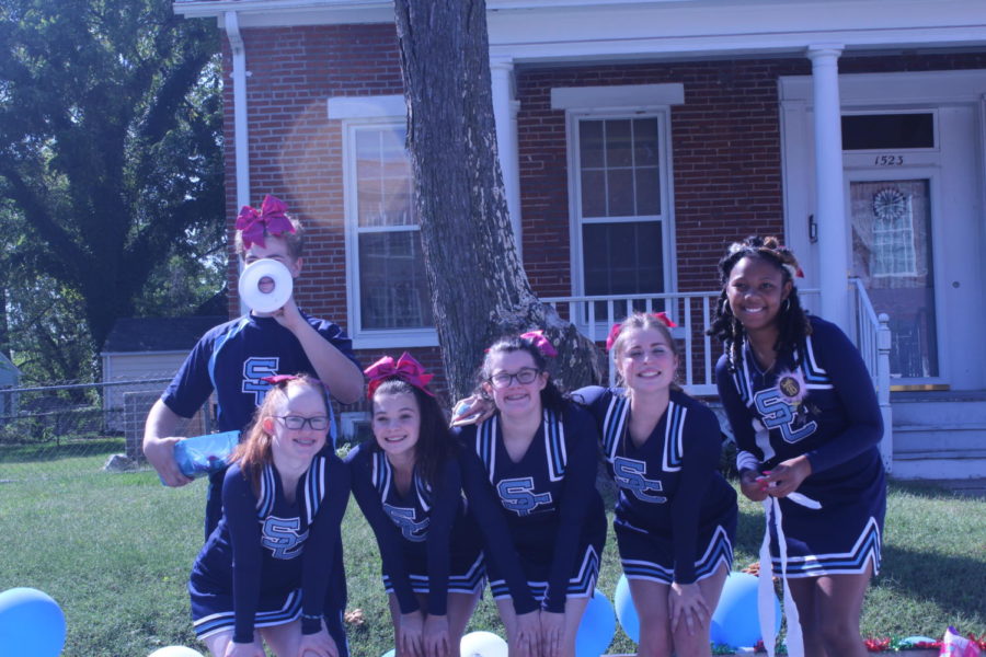 Cheerleaders pose for a picture at the parade.