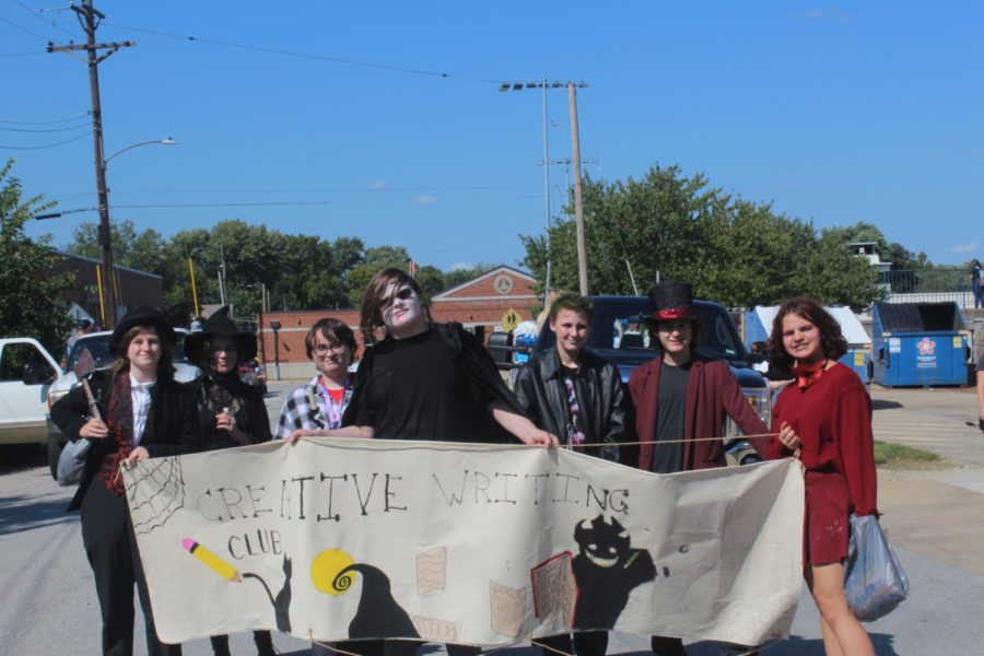 Creative Writing walks in the parade with fun costumes and makeup.