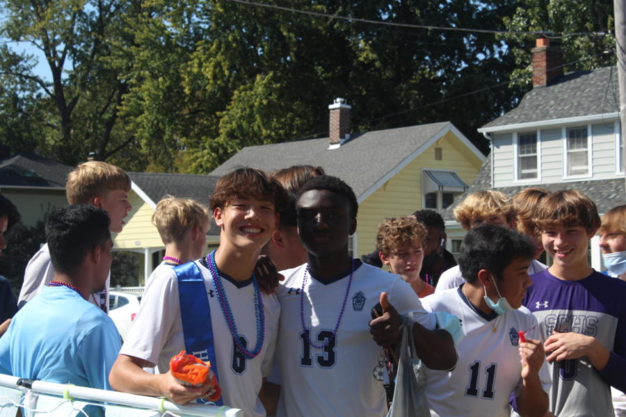 Two members of the soccer team smile for a picture on their float.
