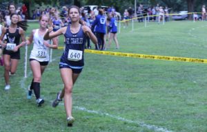 Emma Gilkison giving two thumbs up at a cross country competition on 9/3