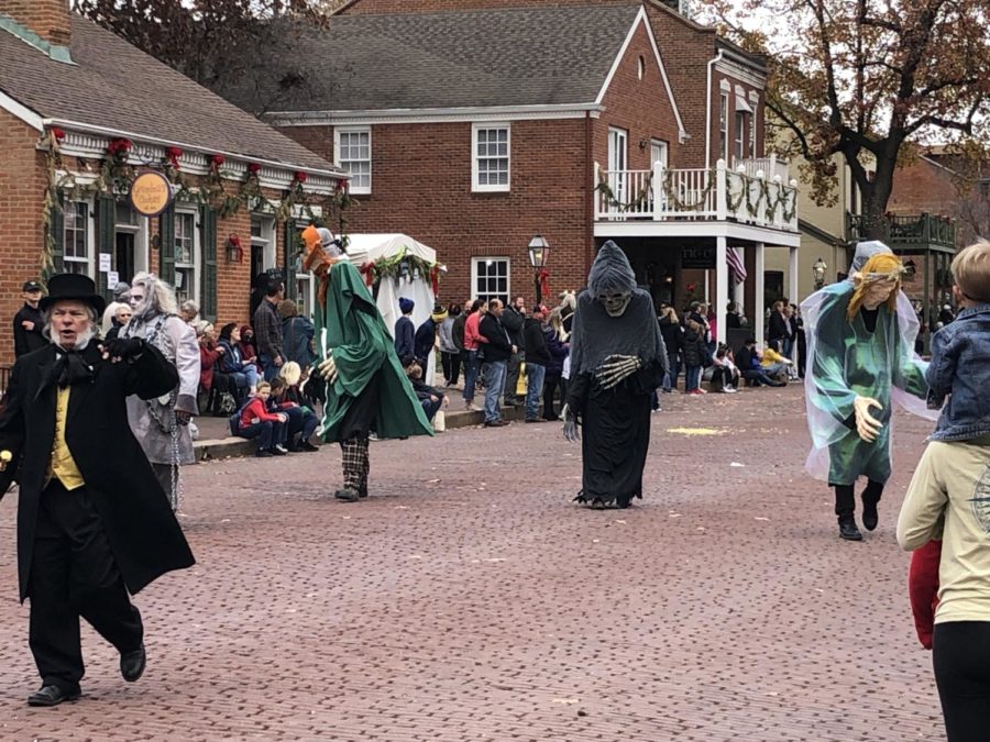 The Ghosts of Christmas past, present and future follow Scrooge and Jacob Marley down Main Street.