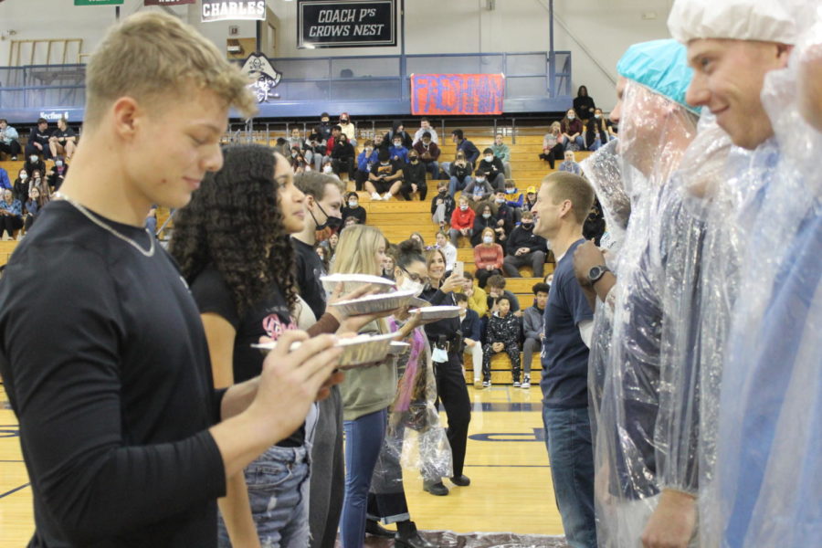 The teachers and students are getting ready to get pied in the face.