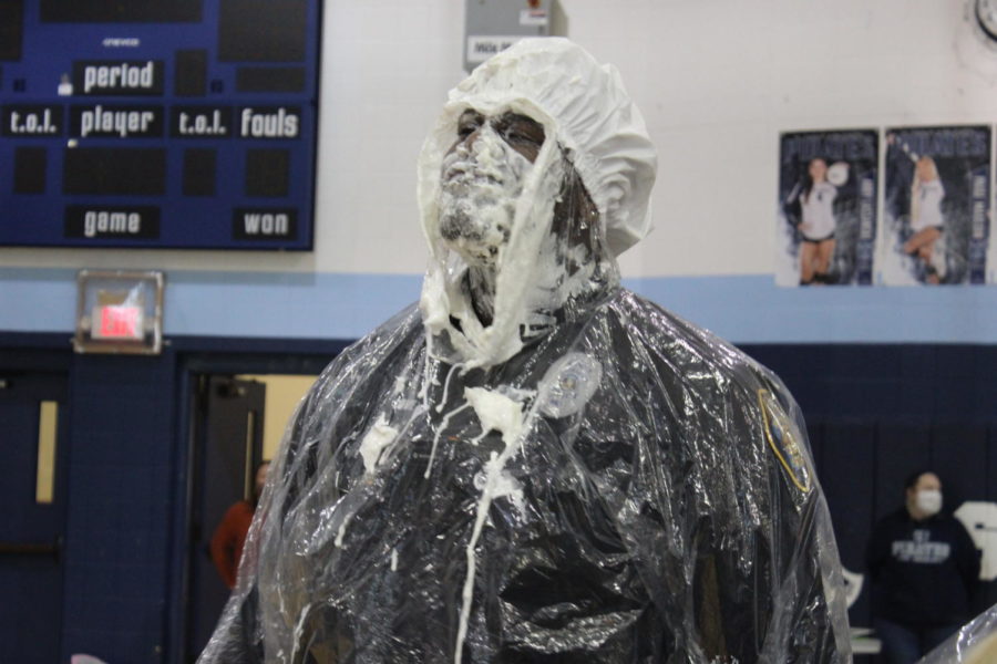 Mr. Forbes covered in pie is looking at the students in amazement .