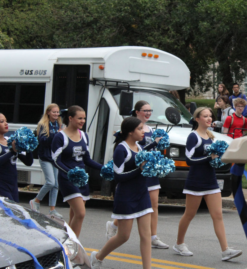 Danceline marches down the parade doing a cheer in the homecoming parade on Sept. 23. 