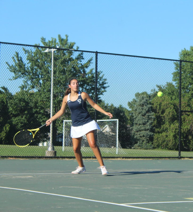 Senior+Alyssa+Birkenmeier+stepping+up+to+hit+the+tennis+ball.