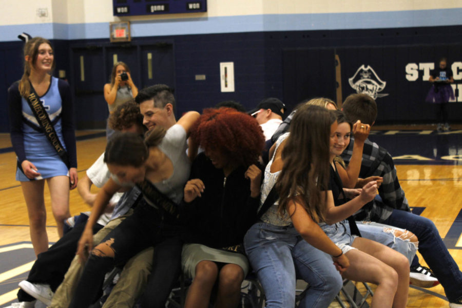 Homecoming court fights for a chair in musical chairs in the homecoming assembly Sept. 23. 