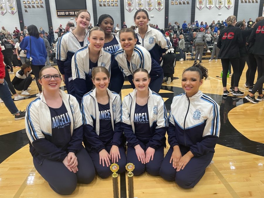 The team poses with their awards at Farmington.