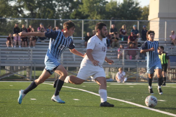 Senior Connor Russell fights for the ball on Sept. 12 against SCW.