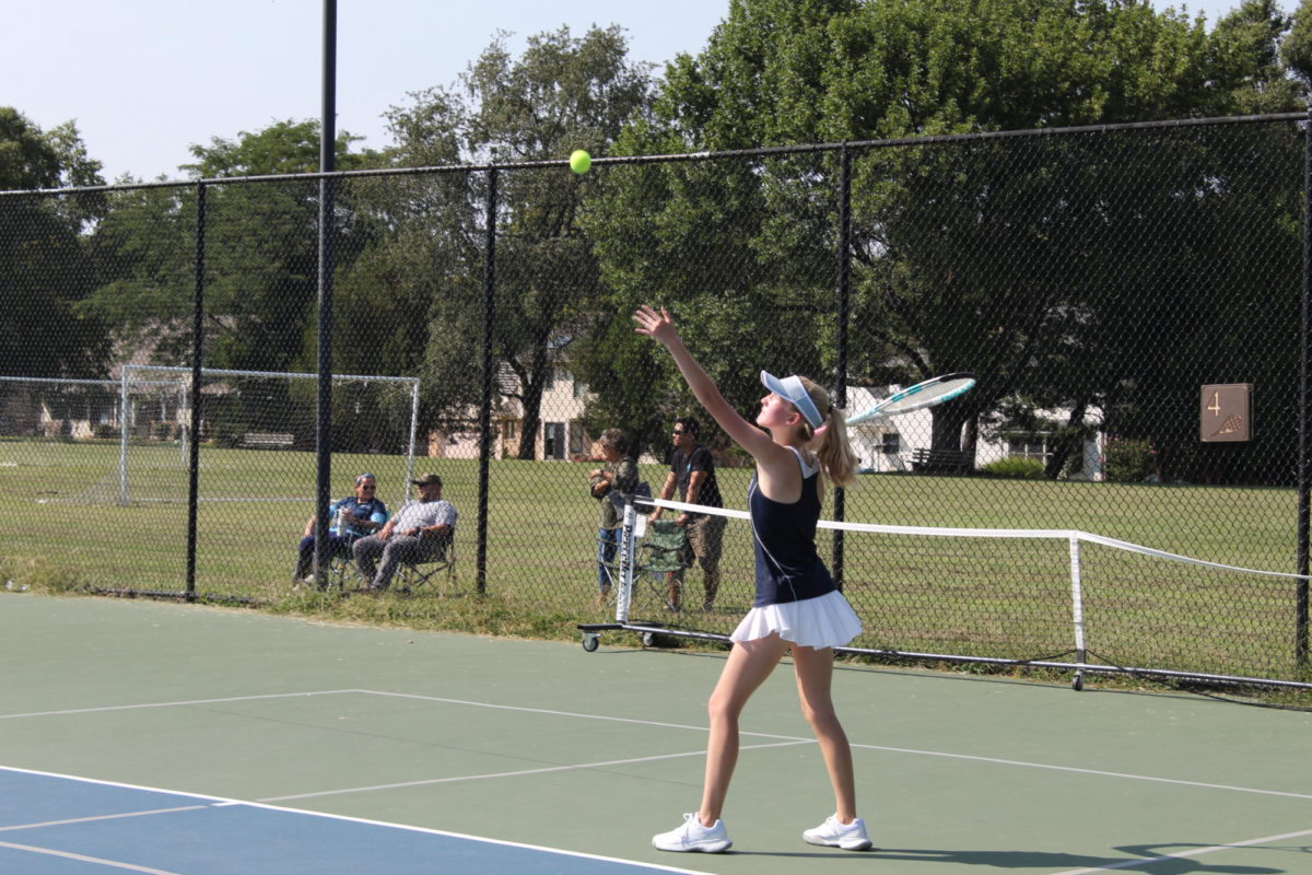 Isabel Lindquist serves the ball on 8/29