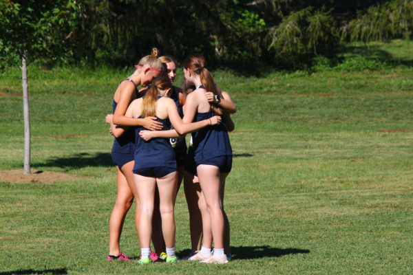 The Varsity Girls Cross Country Team supports each other before the start of the Cross Country Race on Sept. 1st