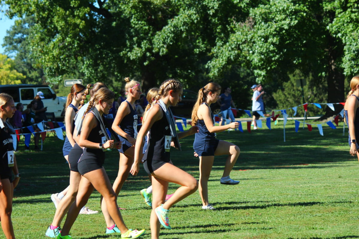 The Varsity Girls Cross Country team prepares themselves to run in the Cross Country race on Sept 1st