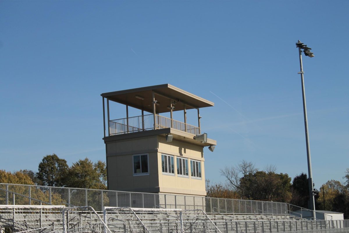 The press box is behind the guest bleachers at the stadium. 