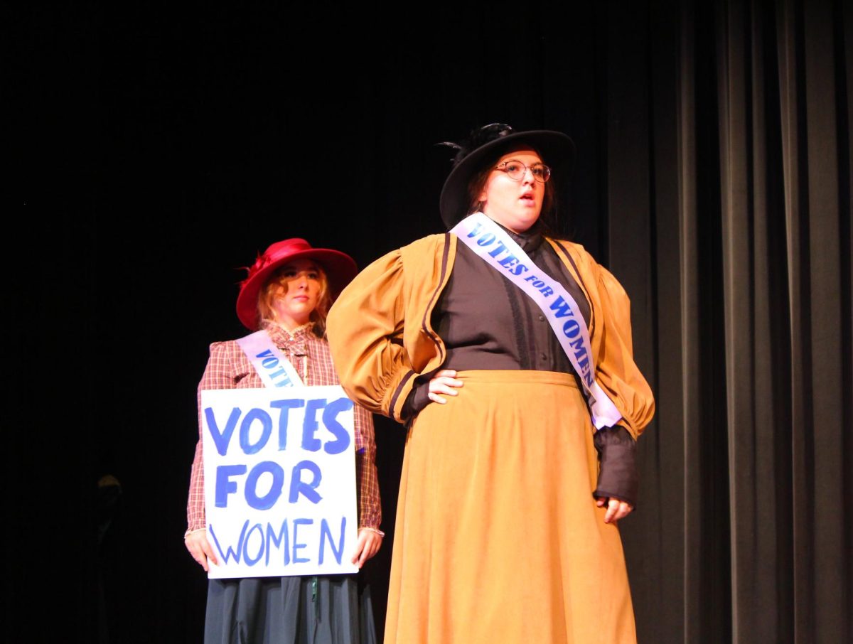Danika Nalepa(left)  and Jessie Morehead protest for womens suffrage. 