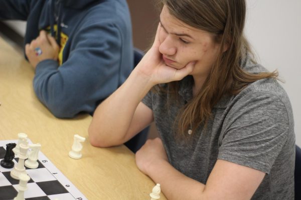 Heavy in thought, senior Lincoln Mosley plays Bug-House in Chess Club on Nov. 13. Mosley teamed up with Donovin Palmer and managed to take down their opponents.