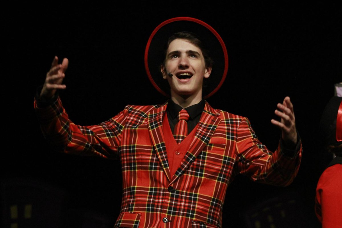 Junior Caiden Wright sings during Act One.
