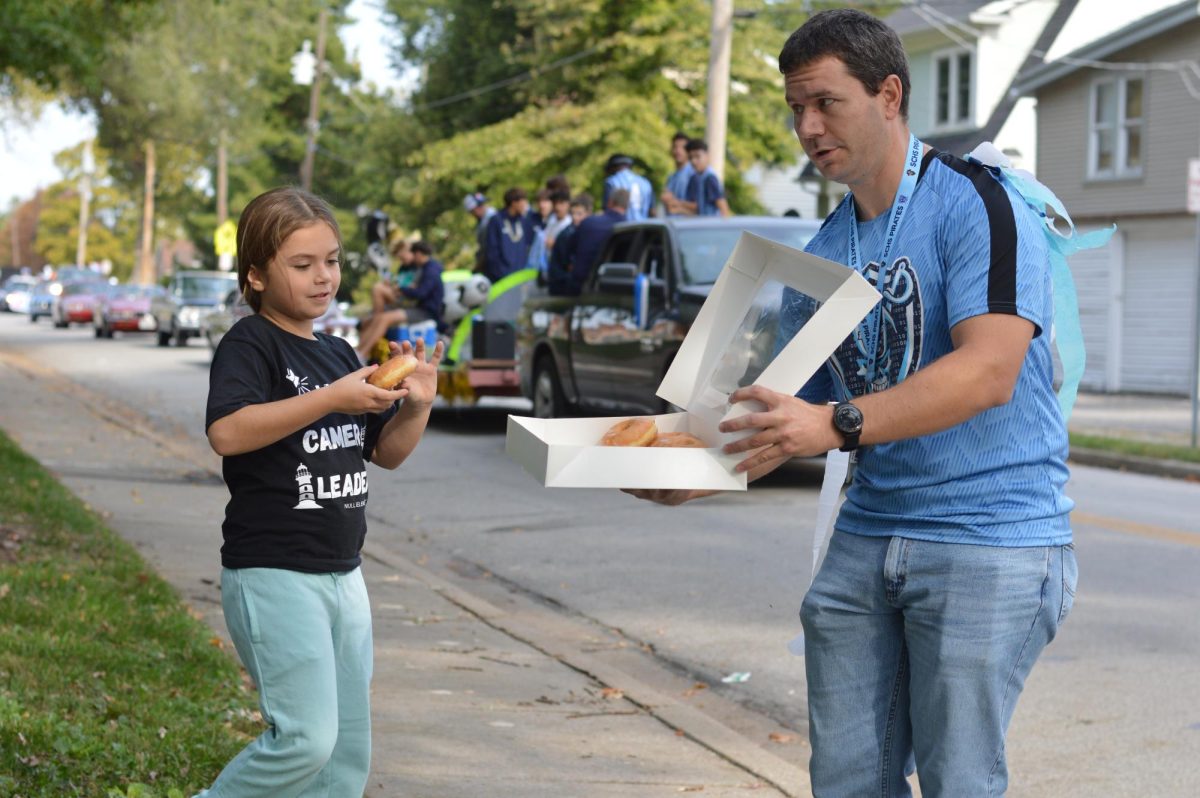 Joseph Messina Hands out doughnuts to the community