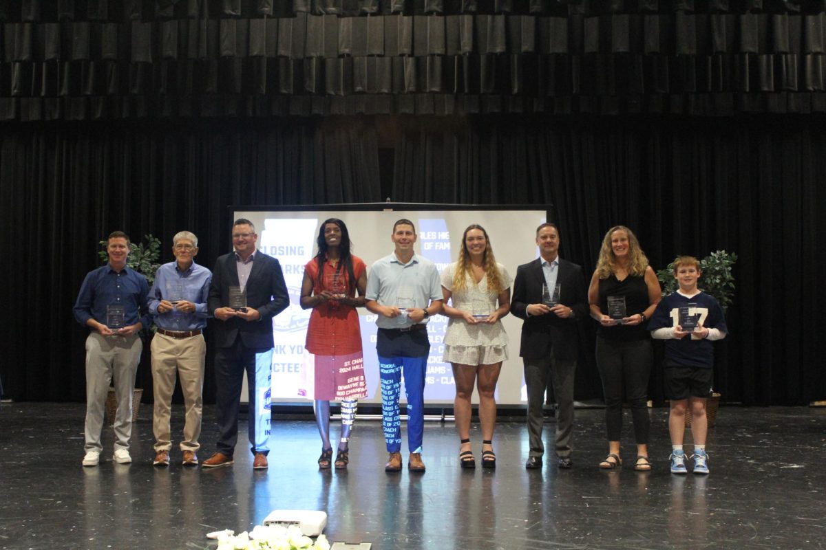 Inductees hold their awards on Oct. 12. 