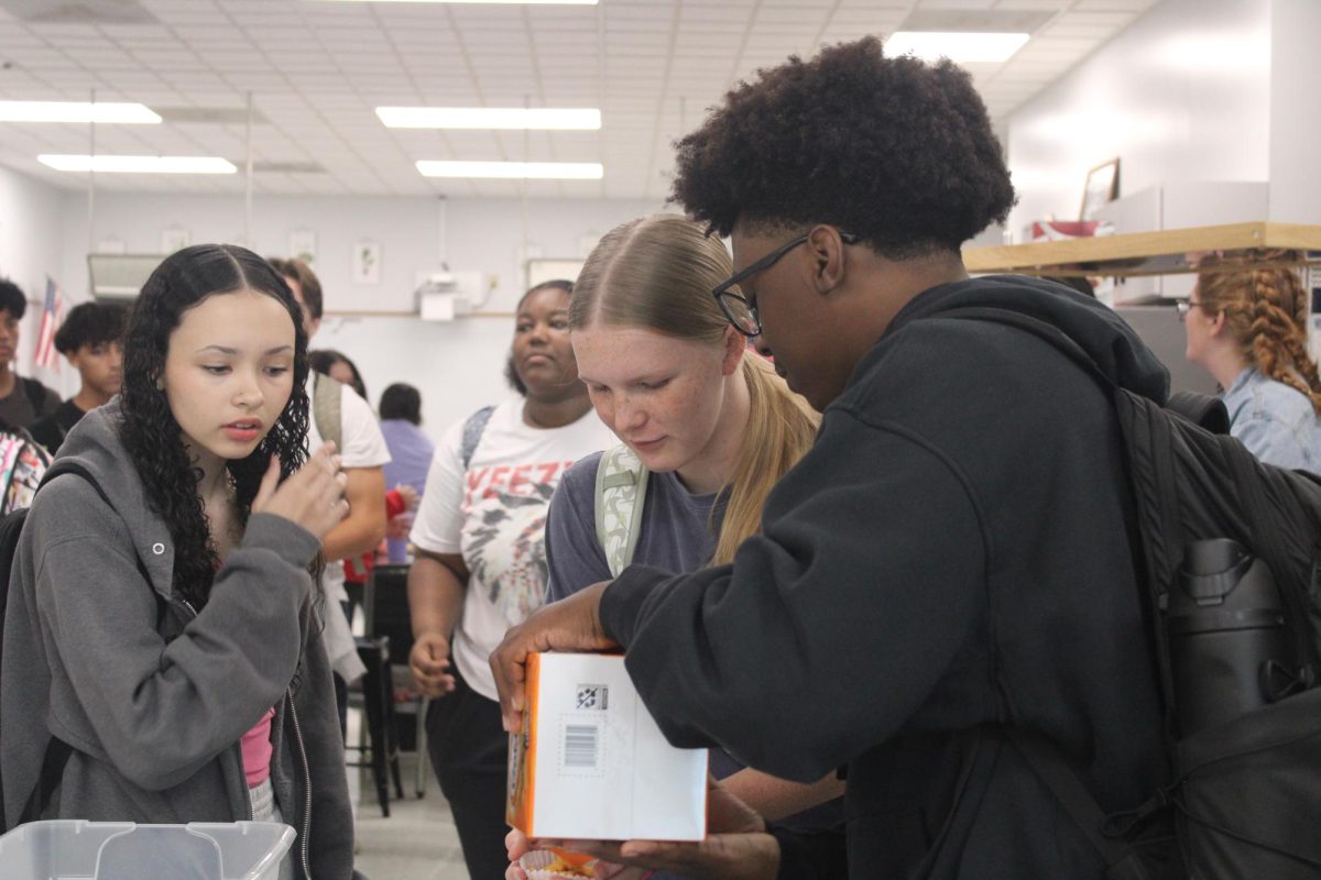 Talking and laughing, Freshman FCCLA members Carter Crumble and Olivia Otten share a snack at the end of their meeting on Sept. 12. This was the second meeting of the year for FCCLA.




