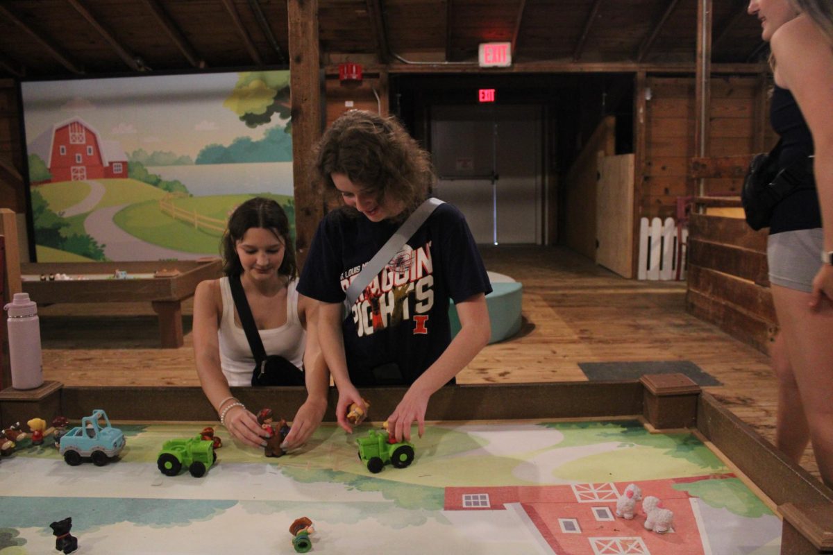 Sophomores Myra Soles and Kaylin Rogers play with toddler toys at Purina Farms on Wednesday Sept. 18. They did this during the French 3 class field trip.