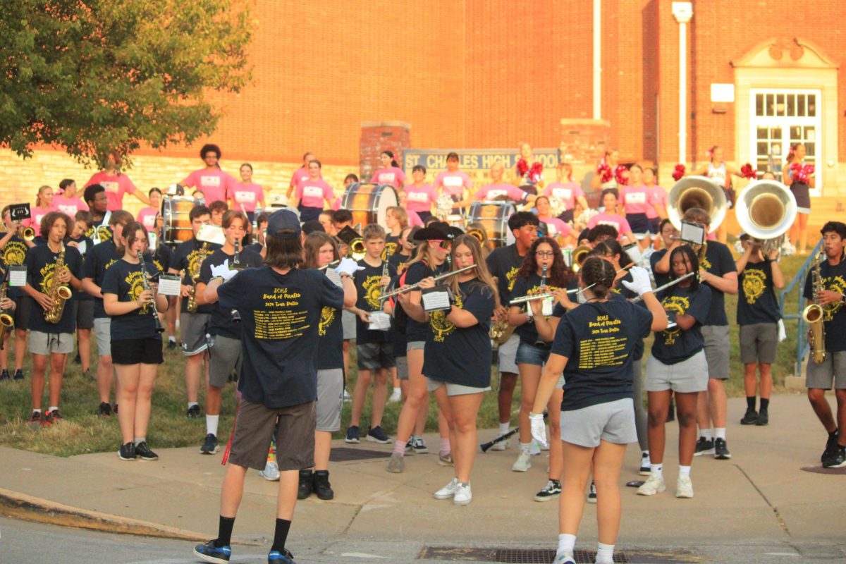 Max Sheils and Colleen Ney conduct the band together.