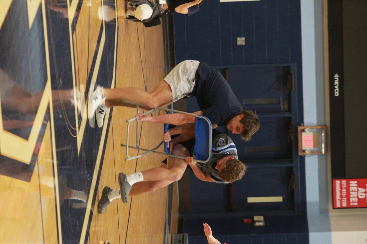 Will Bourgeade and Charlie Reid fighting over the last chair in musical chairs during assembly 