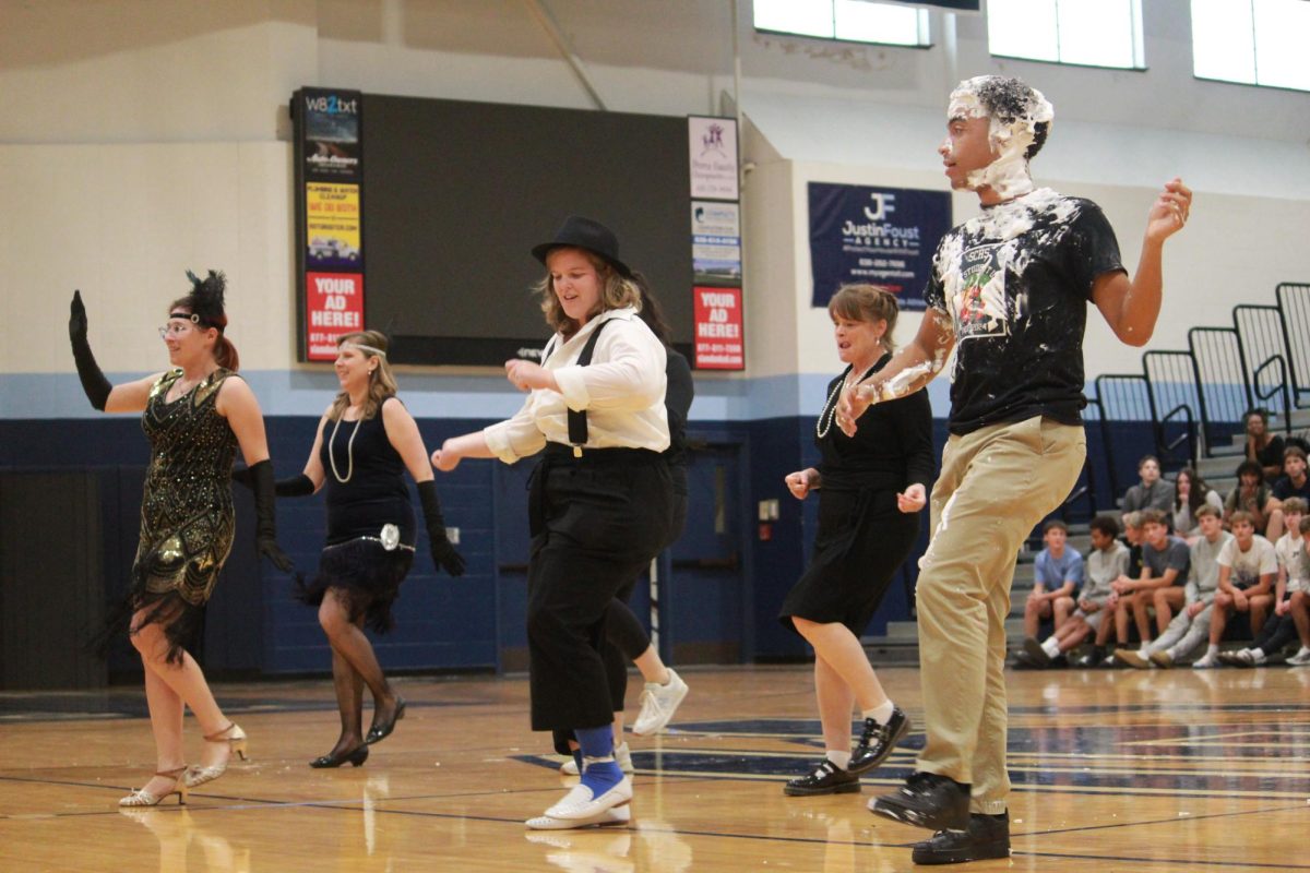 Staff dancing during assembly