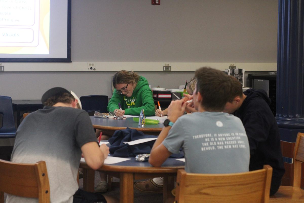  During the first FCA meeting Bryten Kendrick and other members write down how to show Christ throughout the school. While comforted in the silence, they thought of the question asked.