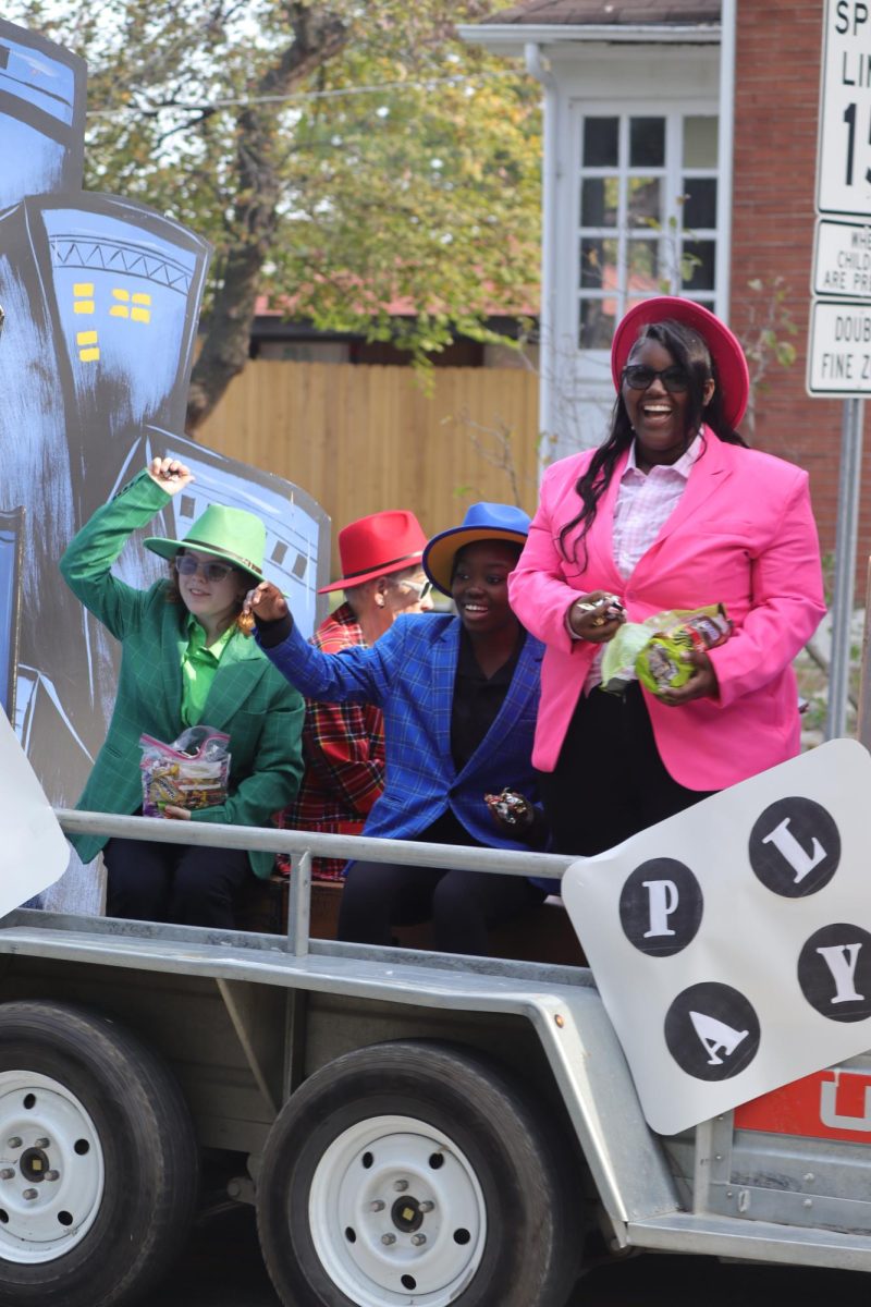 Fall play float throwing candy during parade