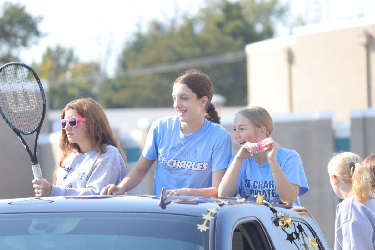 Izzy Eaton, Grace Basler, and Avery Schneider on their float 