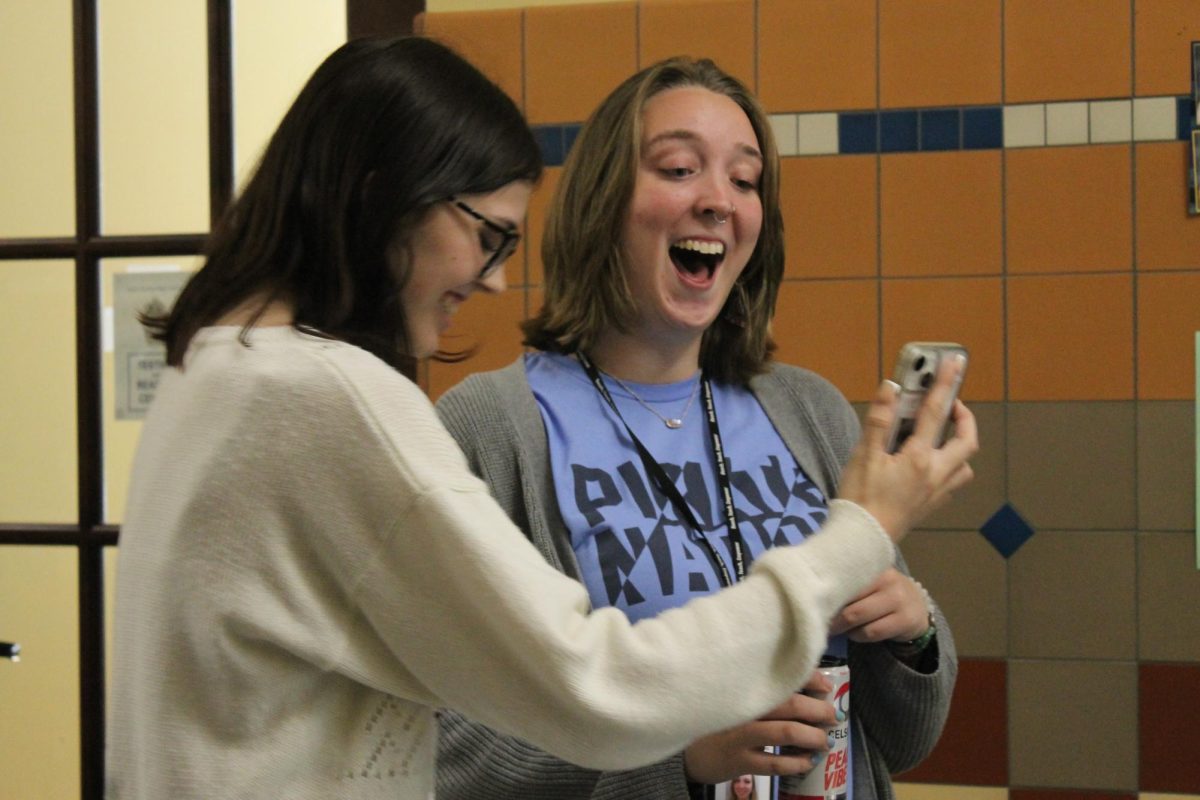 Both laughing, Senior Ariana Allen and English teacher Taylor Beye laugh at how ridiculous Beye looks in the video on September 24th. Beye asked Allen to redo the video for the Yearbook theme again, because she didn’t like how it had turned out. 