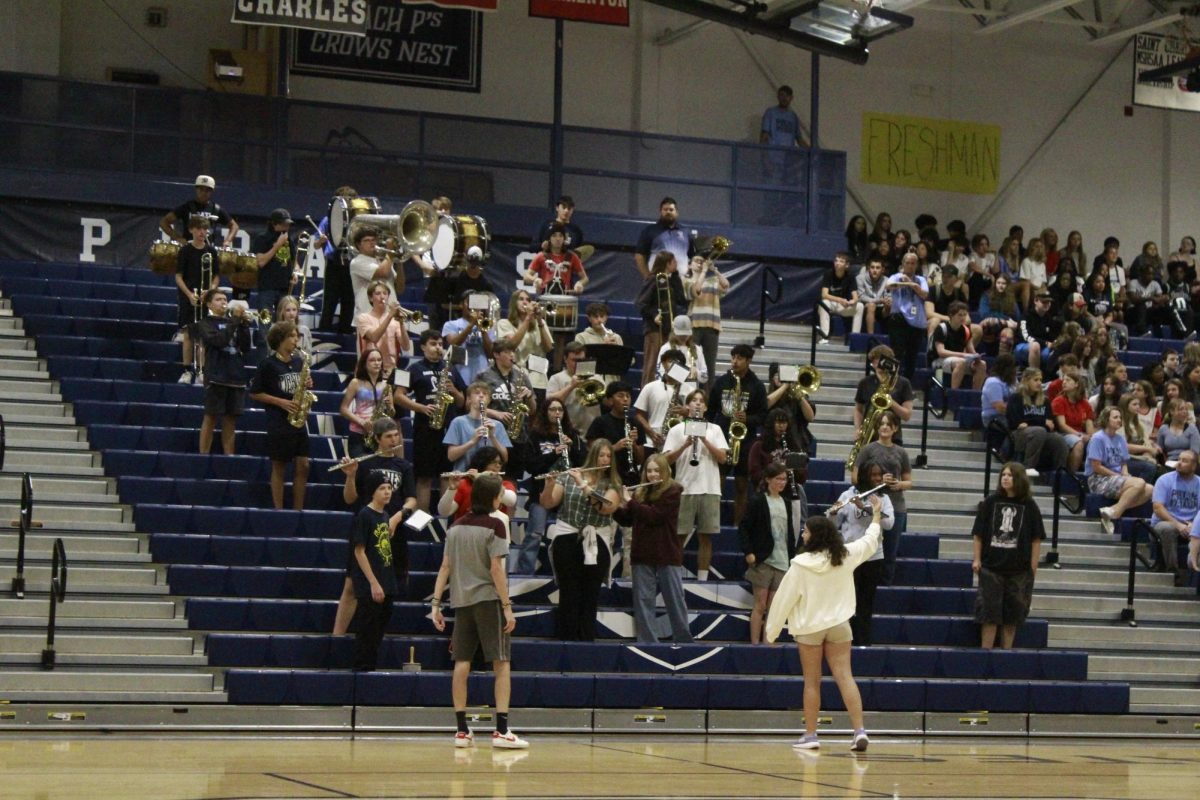 Max Sheils and Colleen Ney conduct the band