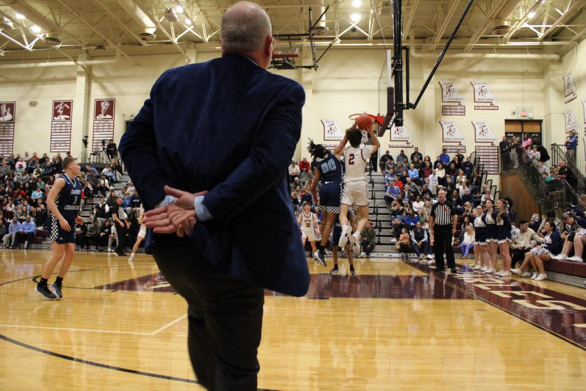 Jadon Salamone blocking the teams shot while coach watches 