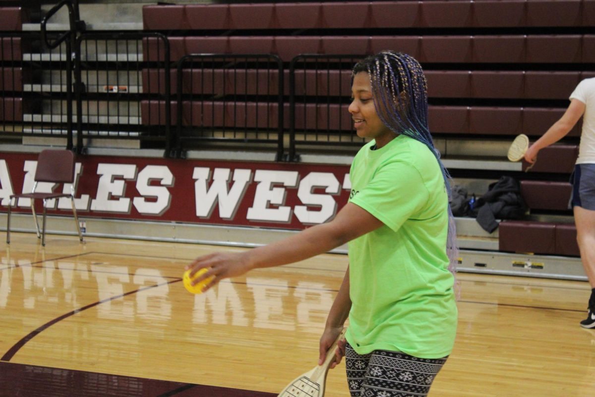 AJ Philogene serving the ball