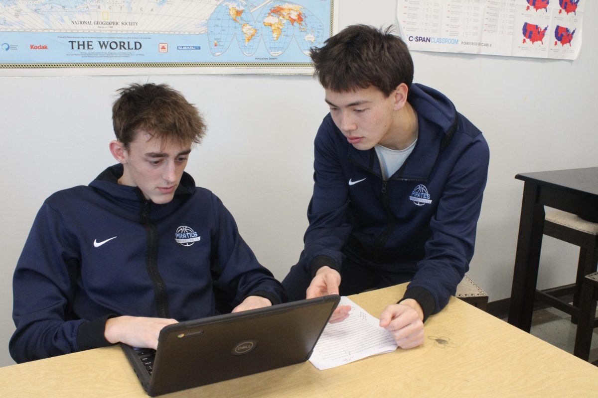 Focused, President of NHS Connor Bayliss helps another fellow NHS student, Isaac Black do his homework on February 25th, 2025. This helped Black get his work done on time.