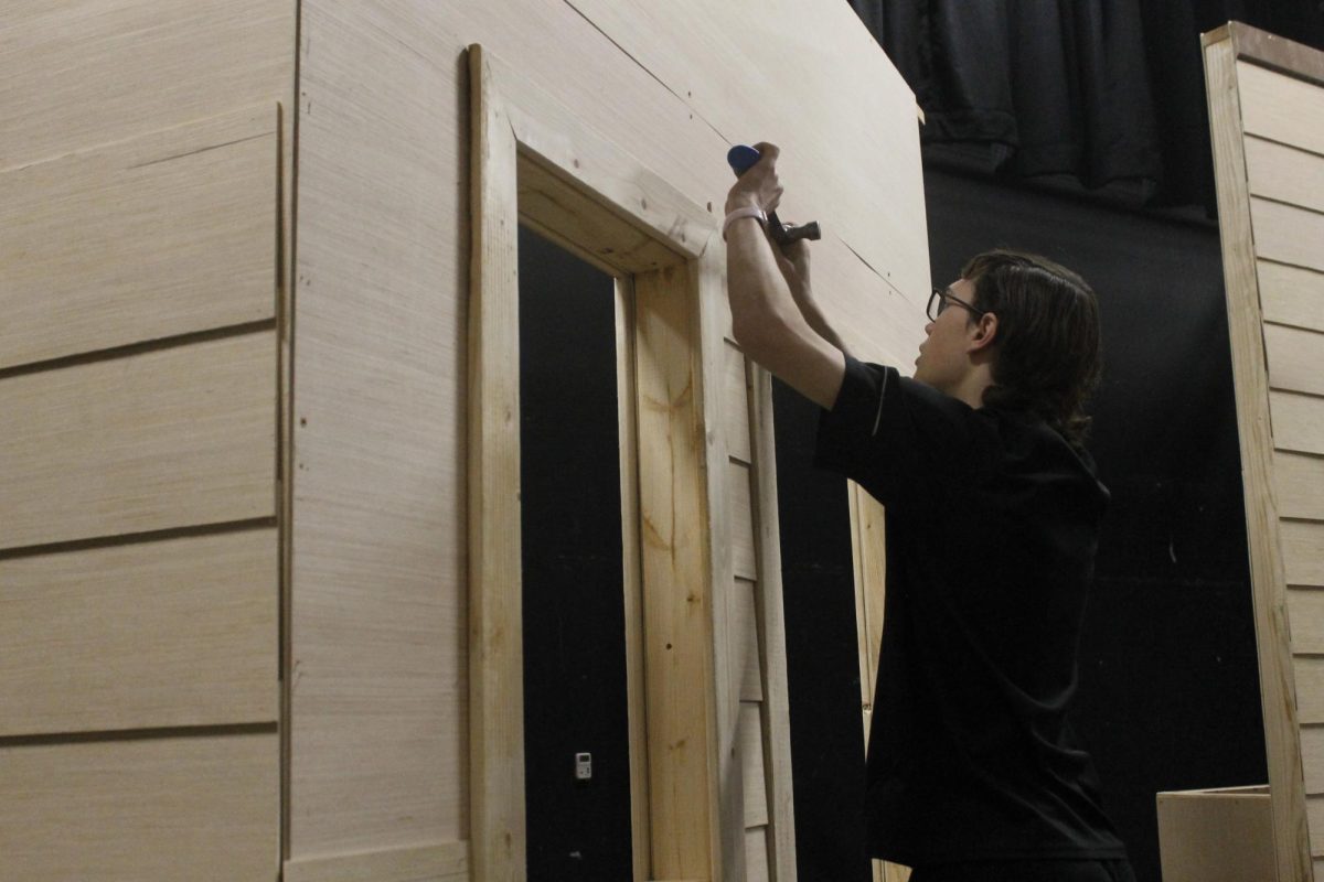 Skillfully on February 22nd, Sophomore Ethan Cox helps with the set build for the spring musical. Ethan, a member of Pirate Players and a cast member in this years musical, helped out with building the set by removing some nails in the wood. 