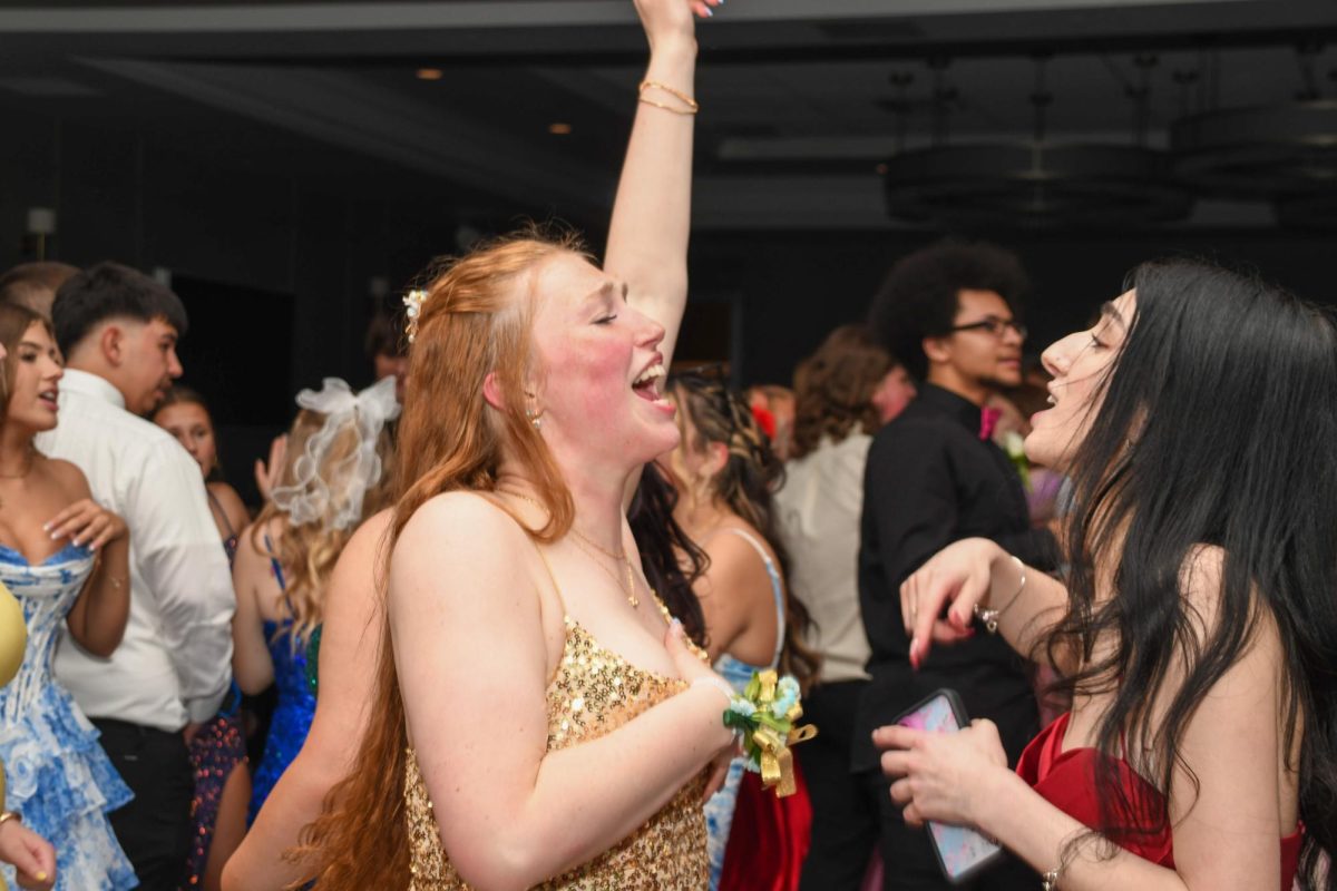 Violet Lewis and Audrey Ebertowski singing at prom. 
