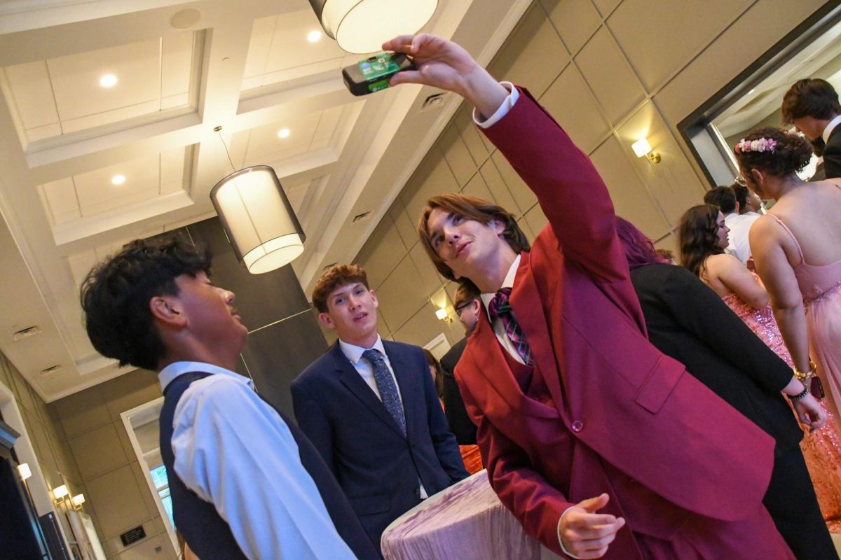 Hunter Wells snapping a selfie with friends.