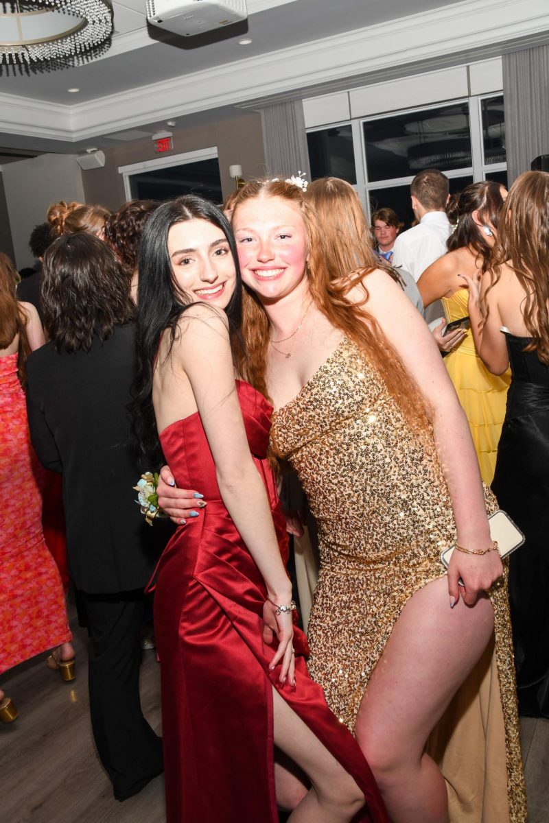 Audrey Ebertowski and Violet Lewis posing for a picture on the dance floor.