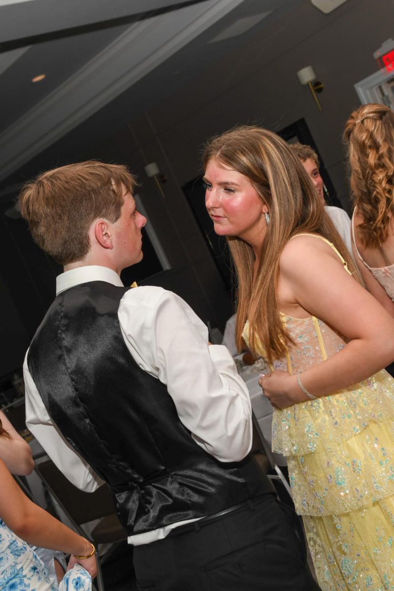 Aiden Hatfield and Caitlyn Buchholtz conversating at prom. 