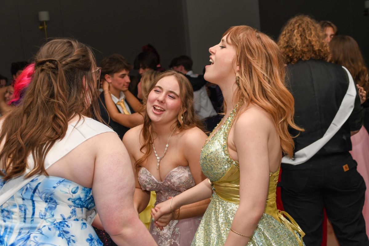 Hope Day, Orion Schaub, and Dani Nalepa singing at prom.