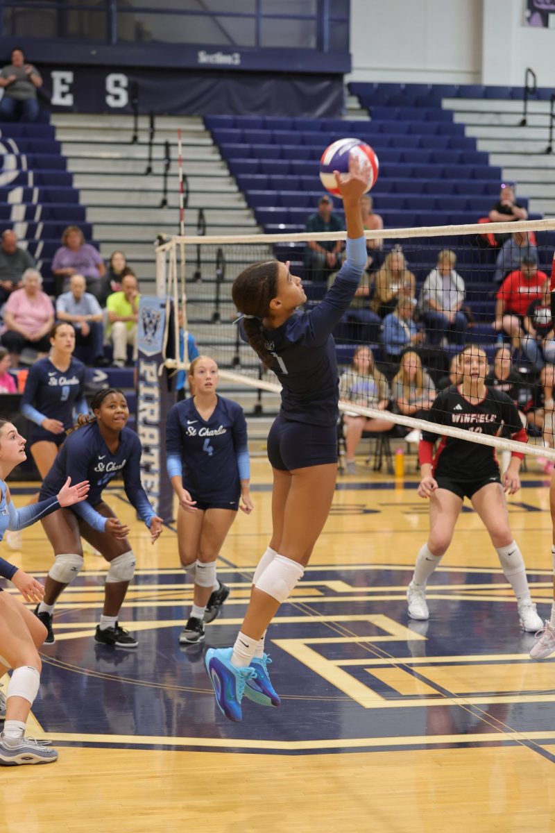 Malia Jones hitting the ball at her opponents.